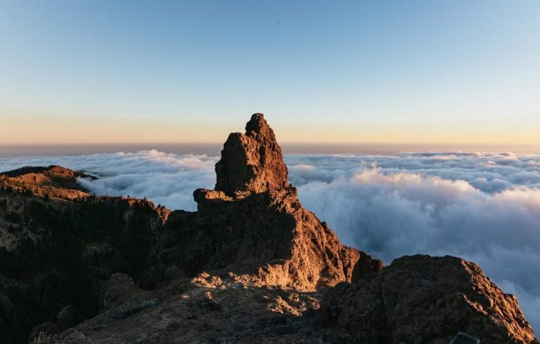 Gran Canaria volcano sunset tour. Mountain peak above clouds. Adventure travel for gay men. Local eats on tour.