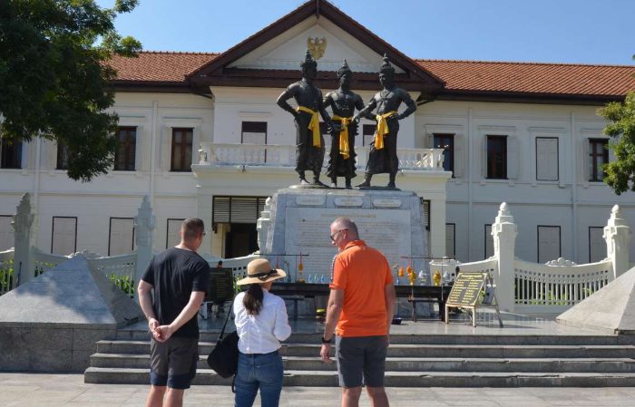 Chiang Mai culture tour: Tourists view the Three Kings Monument. Walk through history in Thailand. Gay travel advice.