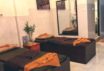 Paradise Massage Phnom Penh: Interior of a massage parlor with two beds, towels, and a mirror. Gay travel advice.