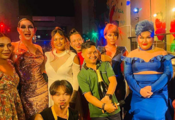 POC Bar Phnom Penh: Group photo inside a gay bar. Drag queens and patrons pose for a fun shot at this popular gay nightlife spot.