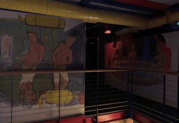Interior of The Boilerhouse gay sauna in Dublin, Ireland. Wall art of men and equipment. Gay travel advice.