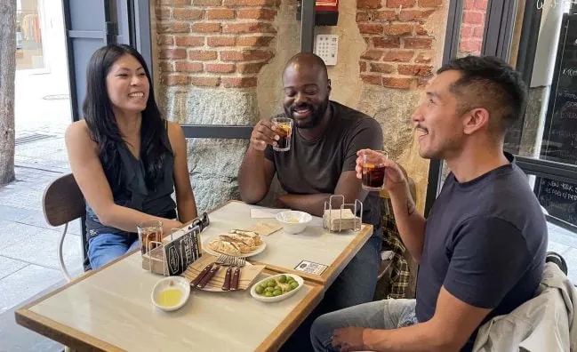 Gay Tapas Madrid: Friends enjoy tapas and drinks on a Madrid LGBT Tapas Tour. Experiencing the food scene in Spain.